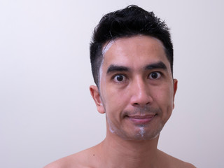 Asian men are washing their face with foam , Men skin care concept