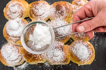 Homemade baking with powdered sugar as traditional holiday cookie closeup.