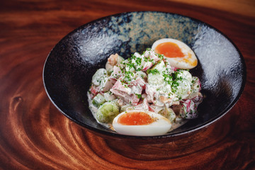 Vegetable salad with boiled eggs mixed with sour cream 