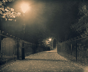 Mysterious and spooky alleyway path to gothic church door, horror and Halloween themed, dark and...