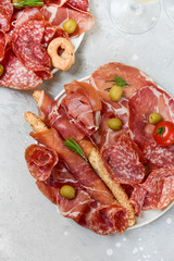 Traditional Italian appetizers ( antipasti ) : salami, bresaola, prosciutto, olives and sticks of cereal bread. Aperitif in Italy in Florence, Rome, aperitif in Milan.  and sticks of cereal bread