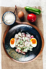 Vegetable salad with boiled eggs mixed with sour cream 
