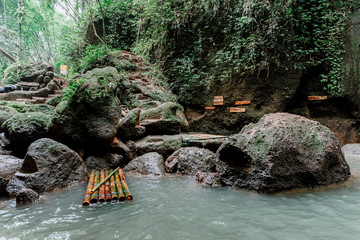 Amazing waterfall Suwat in Gianyar, Bali Indonesia, a stunning island. Jungle waterfall the best cascade in tropical rain forest with rock & turquoise blue pond.