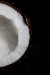 Cutaway coconut on the black background. View from above.