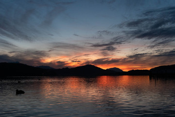 Sunset of lake "wörthersee" with the "pyramidenkogel" in the back