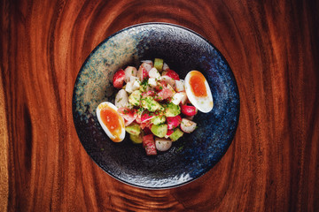 Vegetable salad with boiled eggs mixed with sour cream 