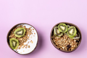 Coconut Bowl With Fresh Kiwi and Granola or Muesli Bowl of Homemade Granola for Healthy Breakfast Diet Food Top View Horizontal