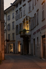 Italian cityscape evening mysterious narrow empty street by night. Night view of the Rovereto city