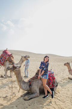 woman near a camel in the Sahara desert