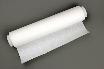 Roll of baking paper on a grey background