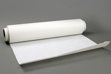 Roll of baking paper on a grey background