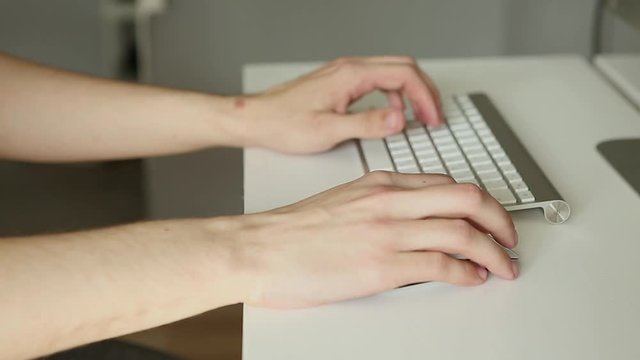 hands typing on keyboard. Man working at the computer. Office worker