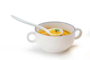 Butternut squash soup and spoon in white bowl isolation on white background, with clipping path