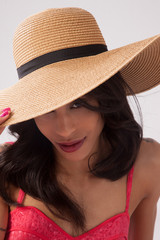 Pretty woman in a straw hat and a smile