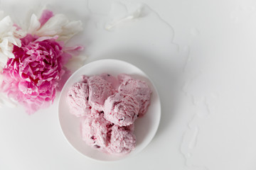 Balls of berry ice cream on white background