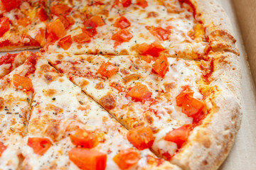 Sliced Pizza With Tomatoes. Vegetarian Italian pizza with melted cheese, red tomatoes.