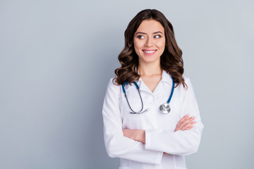 Portrait of her she nice-looking attractive lovely content cheerful cheery skilled wavy-haired girl doc phonendoscope stethoscope folded arms isolated over grey pastel color background