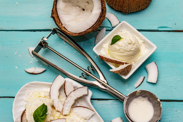 Lactose free coconut ice cream. Special spoon, halves of fruit, flakes