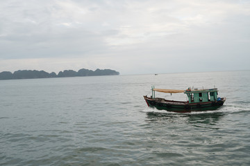 an old fishing boat moored in a Bay on an island in Vietnam