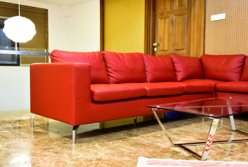Red leather sofa with glass coffee table beautiful illumination light Interior