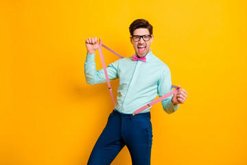 Portrait of funny funky crazy guy pull his suspenders feel candid face expression shout wear good...