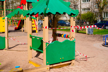 Fototapeta na wymiar Closed children's playground. COVID-19 security and protection measures in the city par