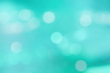 Obraz premium Abstract turquoise bokeh light background with blur.