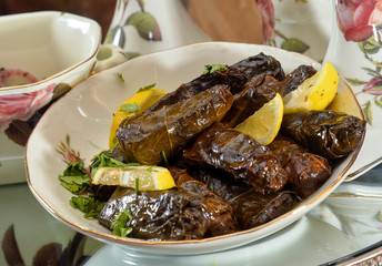 Rice in grape leaves and olives. Food for a traditional oriental lunch. Arabic traditional food celebration for Ramadan and eid