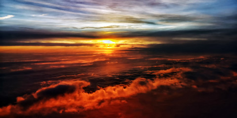 Aerial view of a beautiful dramatic sunrise. Light playing between the clouds