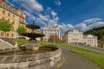 Fototapeta na wymiar Public fountain in spa park - photo of Goethe Square in Marianske Lazne (Marienbad) - Czech Republic