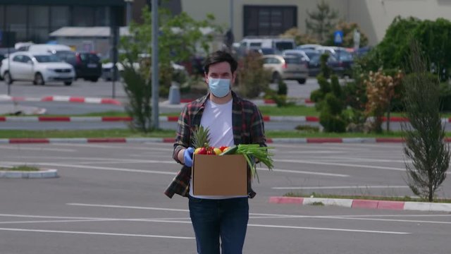 Volunteer person carring fresh vegetables from supermarket store in time of epidemic outbreak