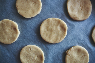 Round pieces of shortbread dough for making cookies or gingerbread
