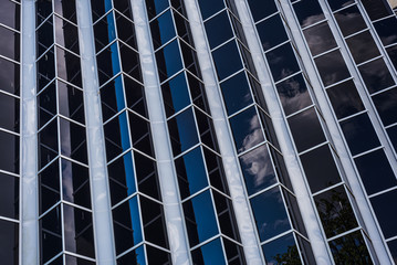 New office futuristic glass abstract background. office glass building architecture. Reflection of the sky in a glass of business building.