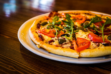 Hot pizza in the delivery plate, fast delivery times, the concept of fast food wasted. Italian pizza