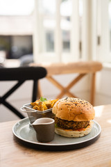 burger with fries on a table in a restaurant