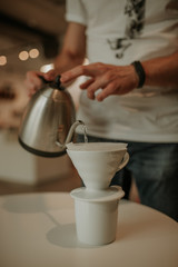 close up of hands making coffee