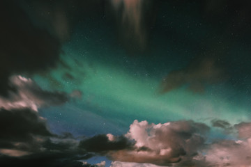 Fototapeta na wymiar Northern lights appear among the clouds.