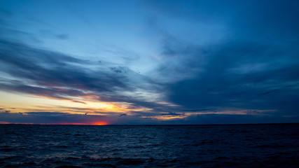 Sunset on the beach, dramatic sky and clouds.