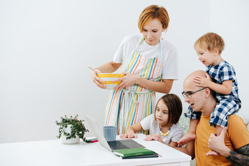 Family looking for entetainment during covid-19 isolation, watching dad work