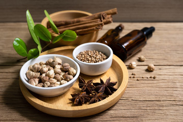 Variety of Thai and Indian spices and natural herbs supplements health food in bowl and spoon on rustic table with copy space.