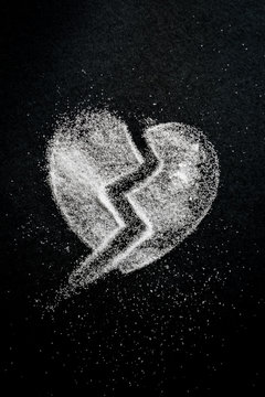 broken heart shape silhouette made with sugar with copy space