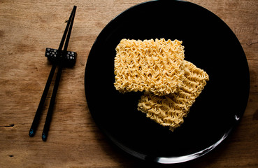 Instant noodles or dry noodles circle isolated on a black background.