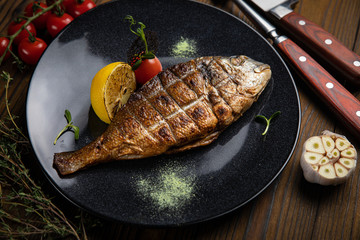 dorada grilled on plate with vegetables