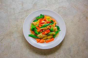 Healthy stir fried vegetables in oyster sauce on white background. Fried vegetables Thai style on white plate.