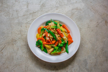 Healthy stir fried vegetables in oyster sauce on white background. Fried vegetables Thai style on white plate.