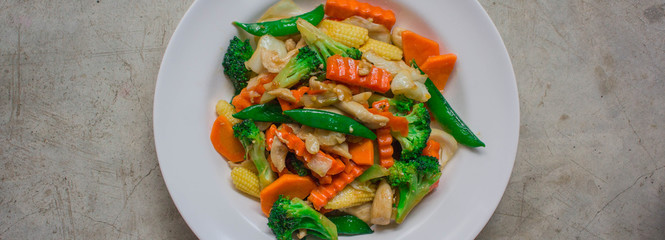 Healthy stir fried vegetables in oyster sauce on white background. Fried vegetables Thai style on white plate.
