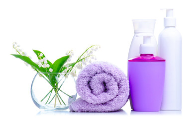 Towel roll, flowers, soap dish with dispenser, gel shower, cream beauty on white background isolation