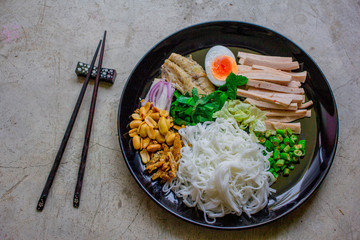 Rice vermicelli spicy salad Thai food. Rice Vermicelli Salad in the black round plate Traditional Southeast Asian cuisine. 