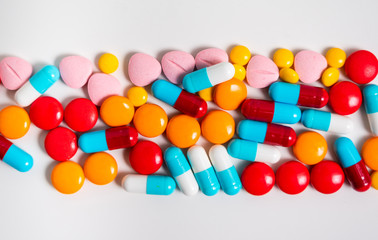 A lot of pills colorful on the white background. Medicine pills, tablets and capsules.