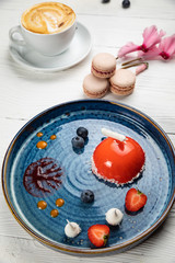 
mousse dessert on a blue plate and a white background